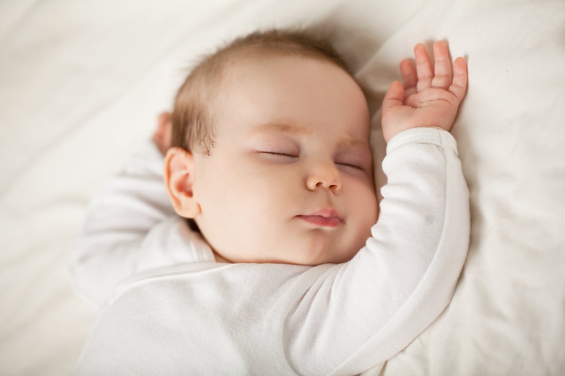 Sleeping newborn baby on white background. Small sleeping child, bedtime (baby up to one month)