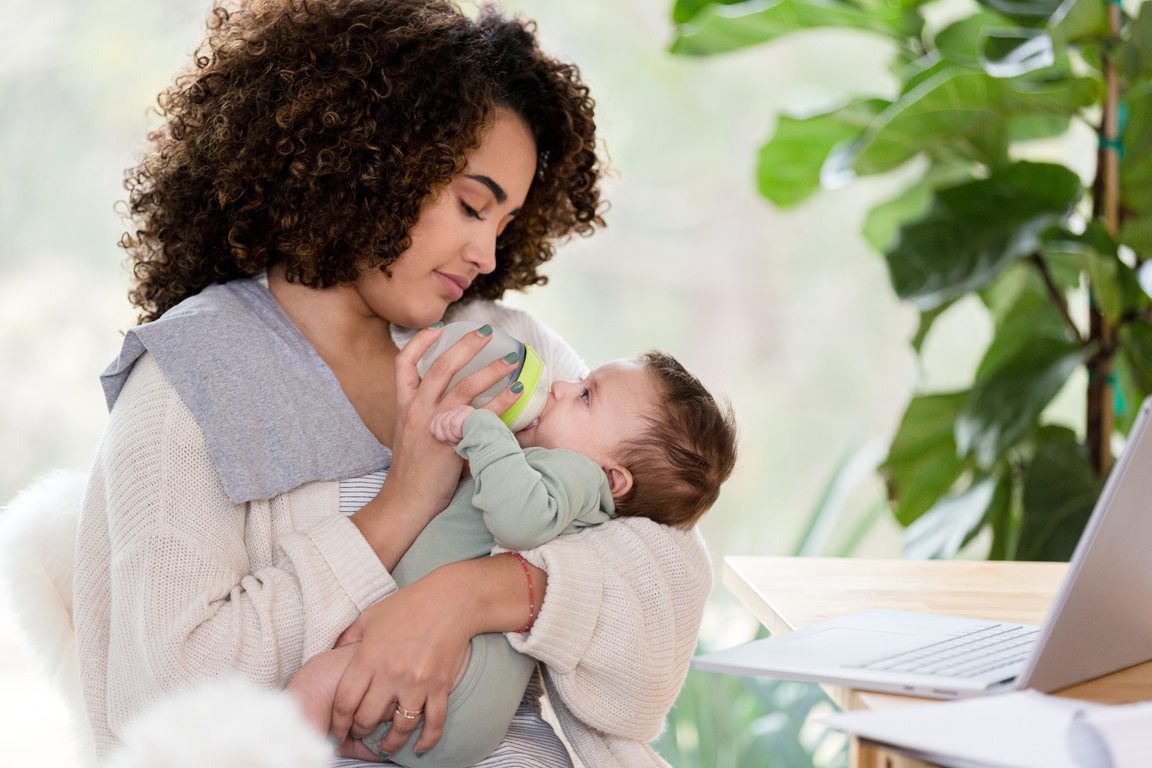 Loving mom gives her adorable baby a bottle